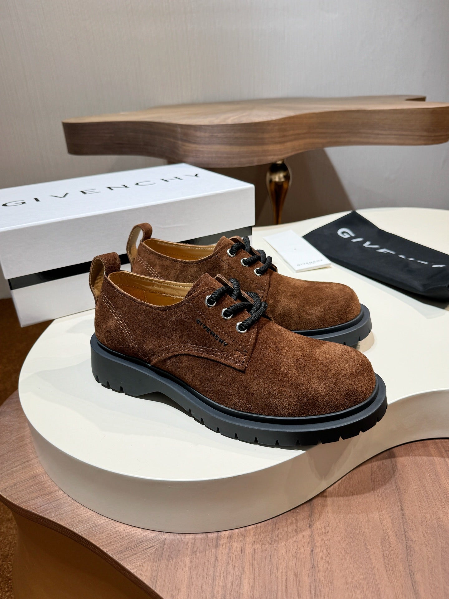 Brown suede lace-up shoes with black chunky soles and lace-up front