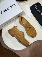 Tan suede lace-up shoes pair with chunky brown lug soles
