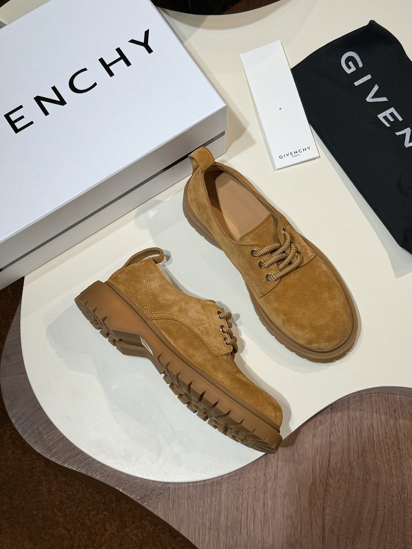 Tan suede lace-up shoes pair with chunky brown lug soles