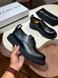 Black lace-up leather shoe with chunky rubber sole, front view