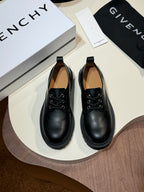 Black leather lace-up shoes with round toe and black laces, pair on display