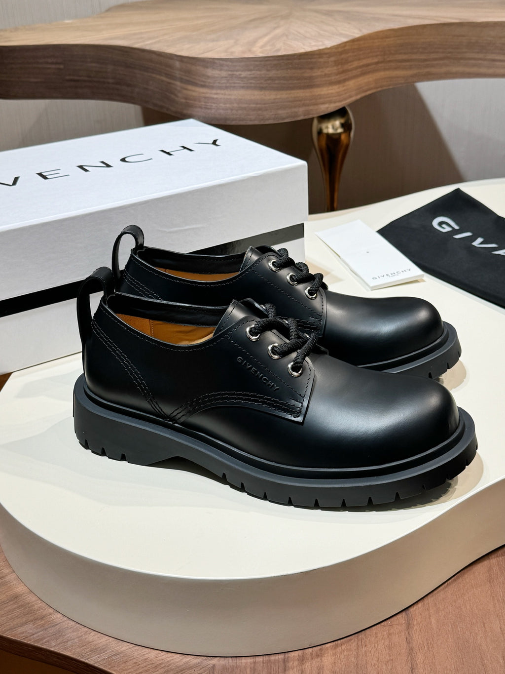 Black leather lace-up shoe pair, polished toe with lace-up closure