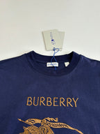 Dark blue short-sleeve T-shirt with Burberry text and gold horse graphic