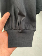 Ribbed sweatshirt hem and cuffs on dark knit fabric