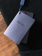 Black sweater with hanging PRADA logo price tag