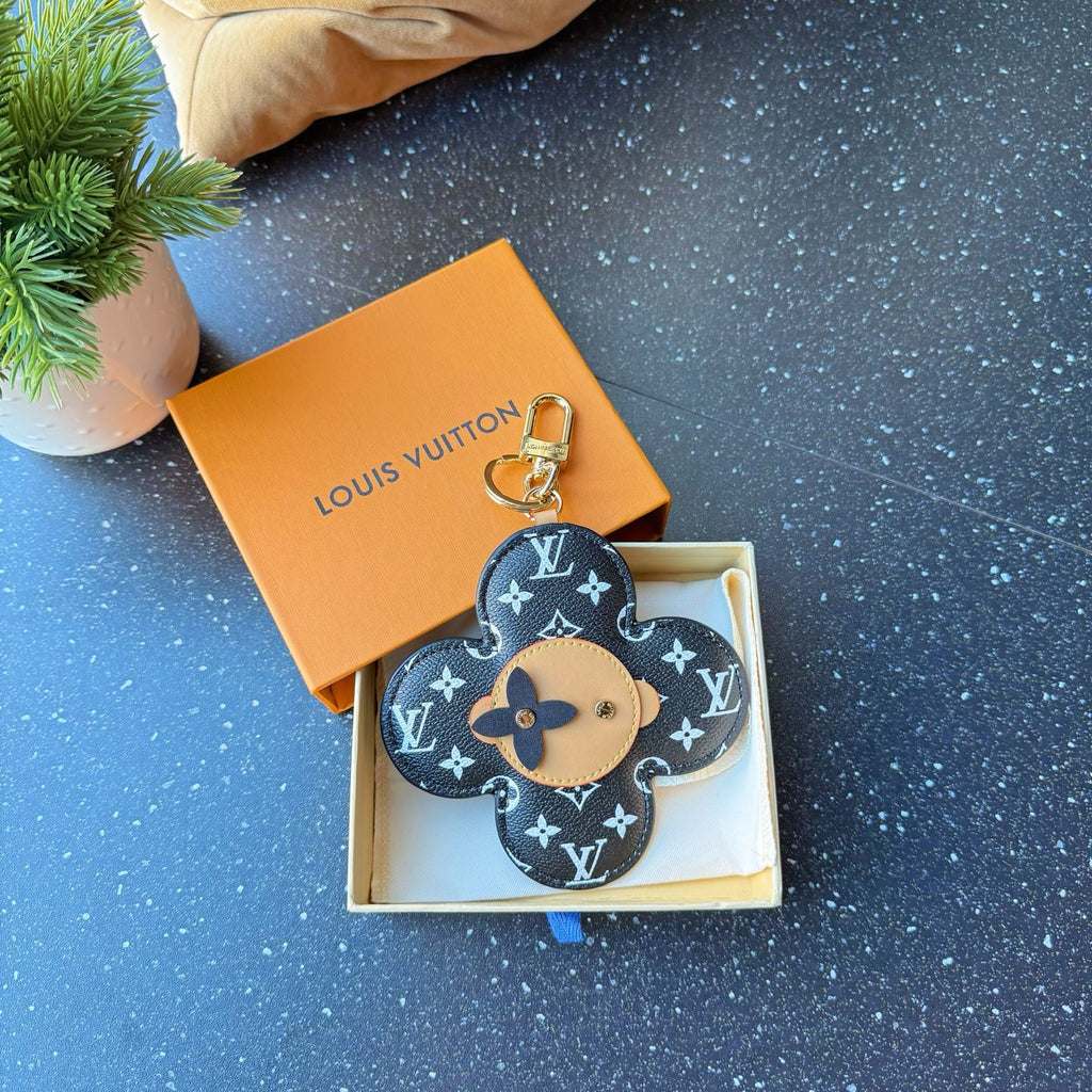 Louis Vuitton monogram flower charm keychain with tan center and gold loop