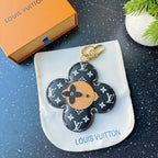 Louis Vuitton monogram flower charm keychain with tan leather center and gold hook