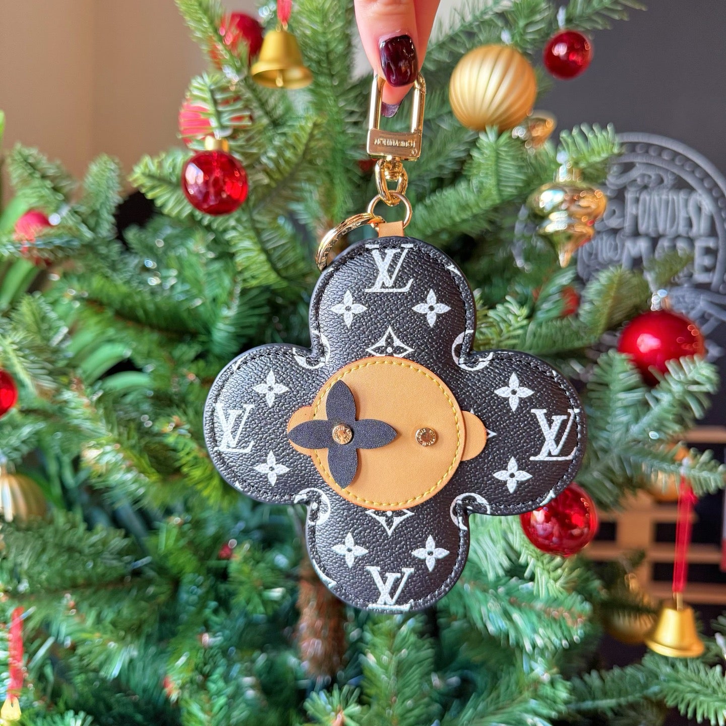 Louis Vuitton monogram flower keychain charm hanging on a Christmas tree