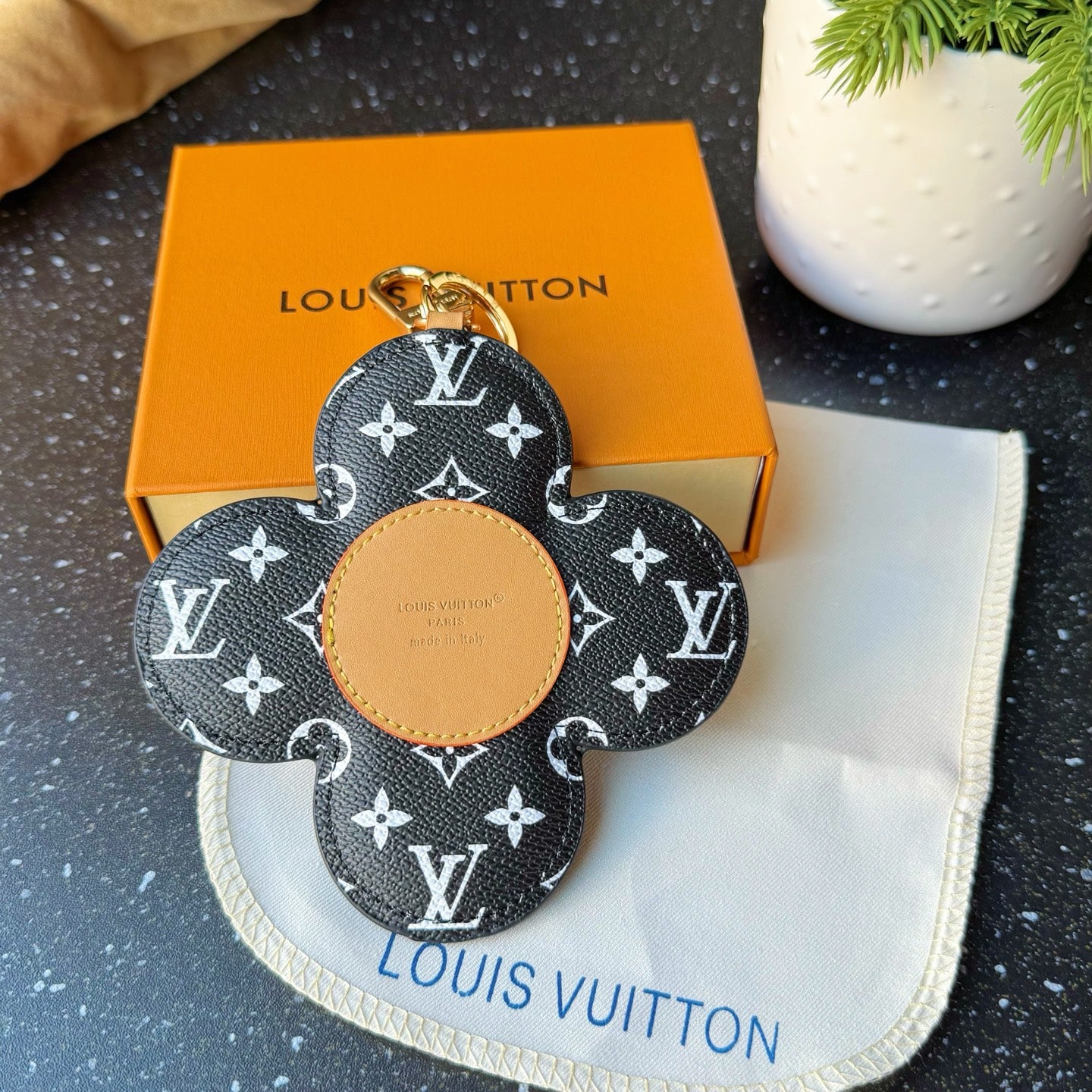 Louis Vuitton monogram flower charm keychain with tan center and gold clasp