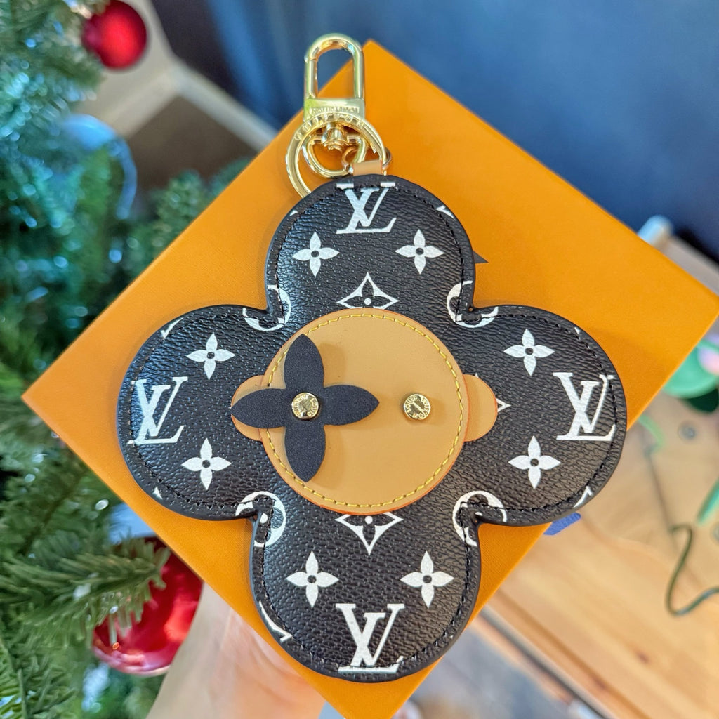 Louis Vuitton monogram flower charm keychain with tan center and gold top ring