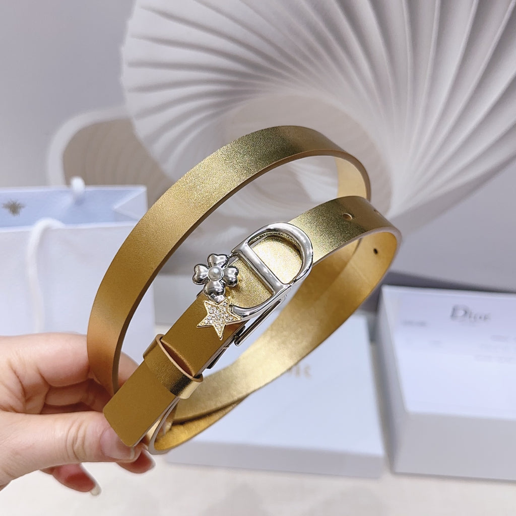 Dior belt with gold strap and silver buckle, star charm and floral studs at clasp.