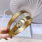 Dior belt with gold strap and silver buckle, star charm and floral studs at clasp.