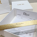 Gold Dior belt strap with engraved “Christian Dior” text across the band.