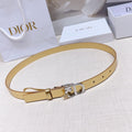 Dior belt in gold leather-look with silver buckle and star charm near clasp.