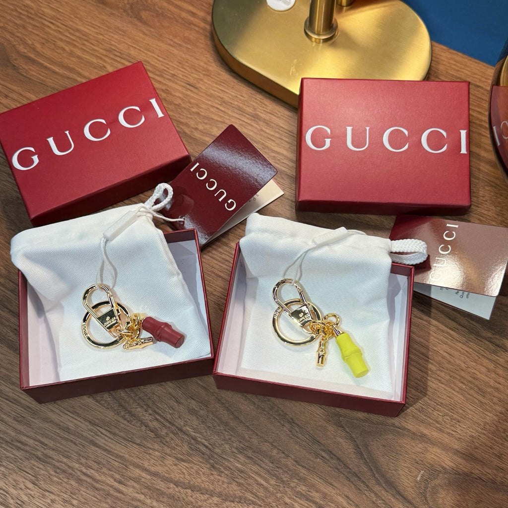 Gucci keychain accessories in boxes with dust bags: gold ring and lime green charm