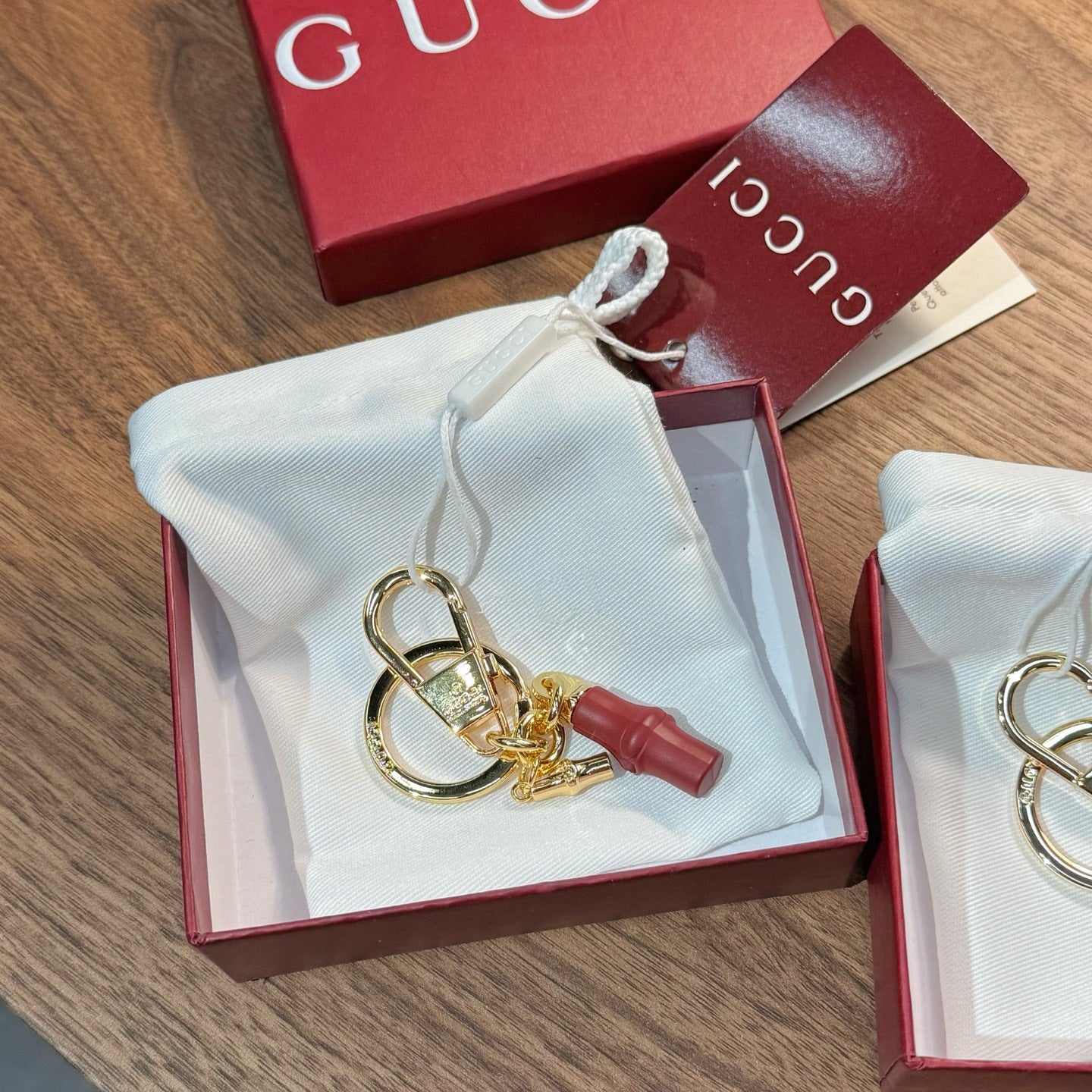 Gucci keychain with gold rings and red leather charm in gift box