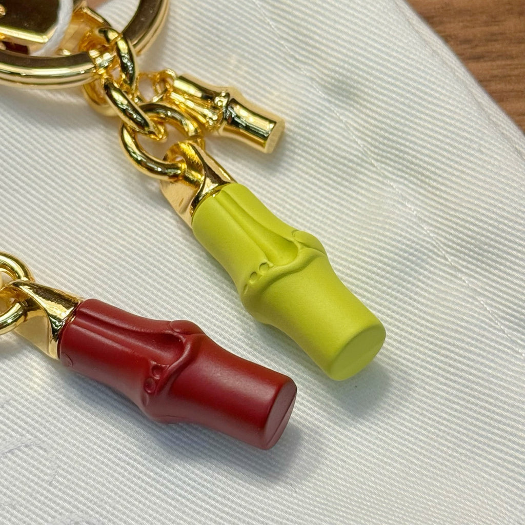 Gold-tone keychain with lime and red barrel charms, lobster clasp, and chain links