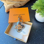 Louis Vuitton monogram flower keychain charm with tan center and silver ring
