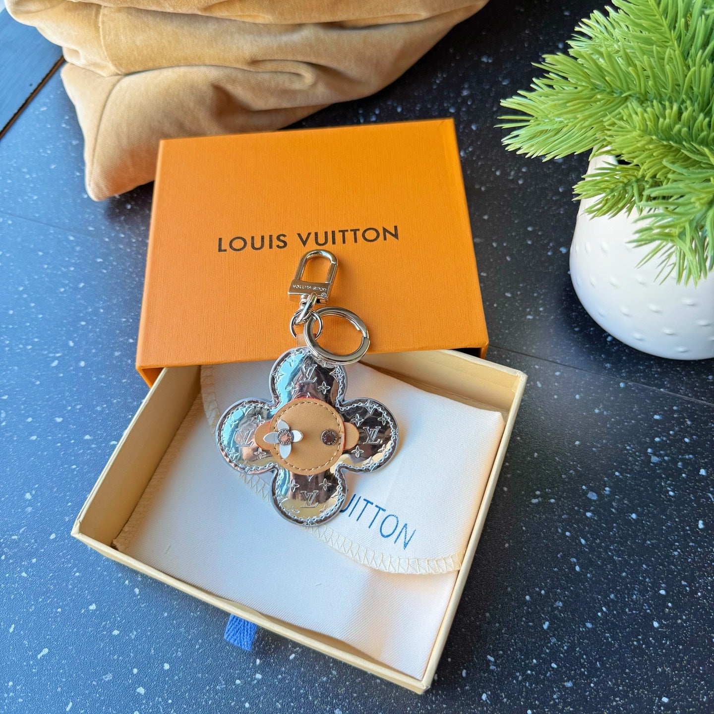 Louis Vuitton monogram flower keychain charm with tan center and silver ring