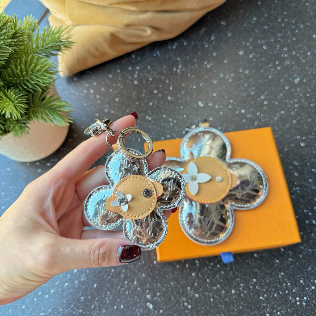 Set of Louis Vuitton monogram flower keychain charms with tan centers and rings