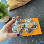 Set of Louis Vuitton monogram flower keychain charms with tan centers and rings