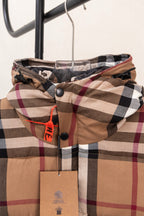 Plaid hood with zipper front and snap buttons; brown, black, white, and red check