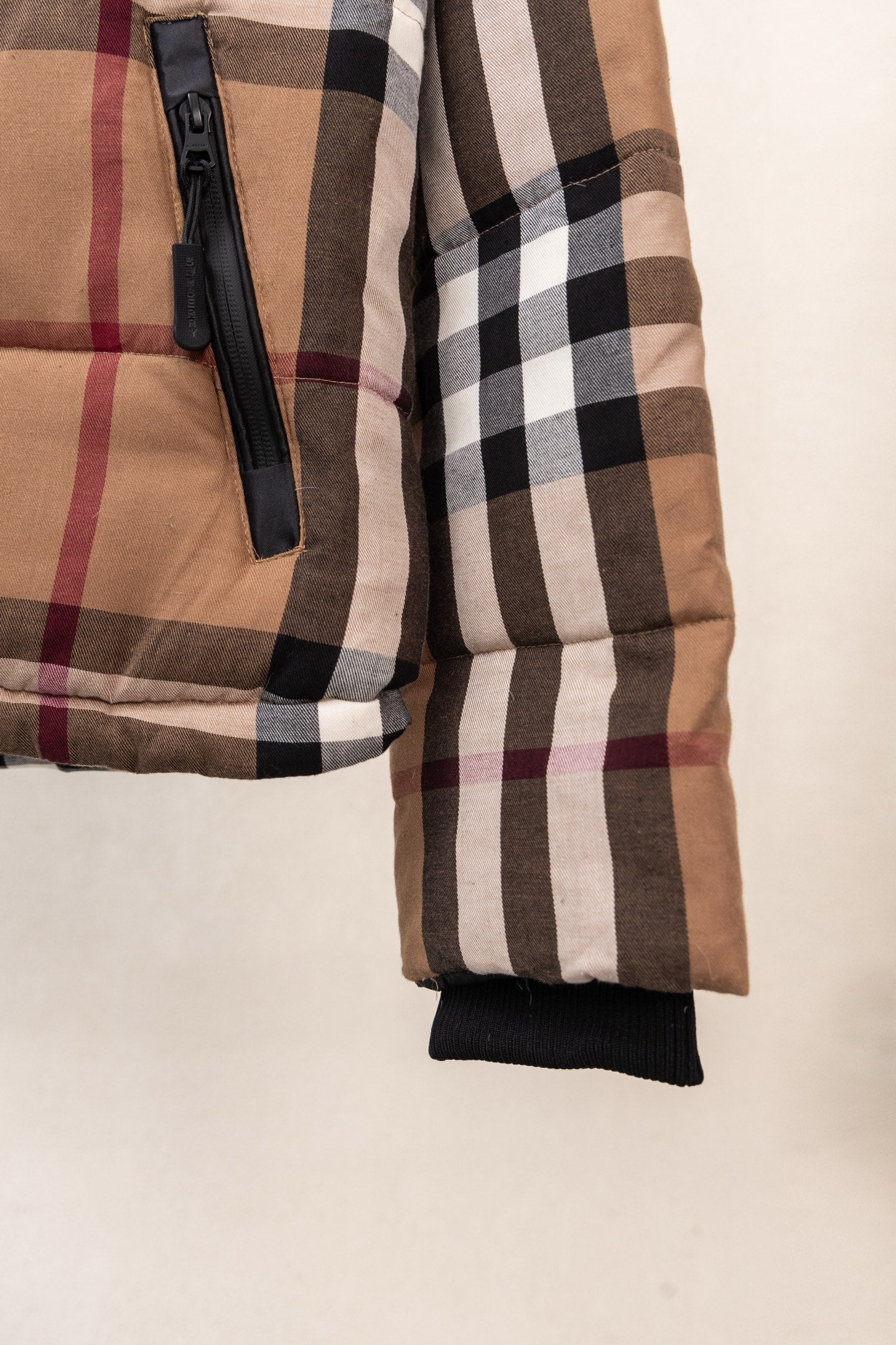 Burberry plaid puffer jacket sleeve with black zipper and elastic cuff