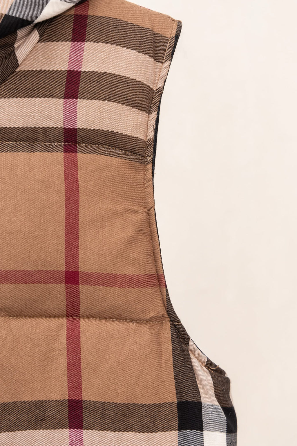 Burberry long plaid puffer jacket with brown quilted panels and vertical check stripes