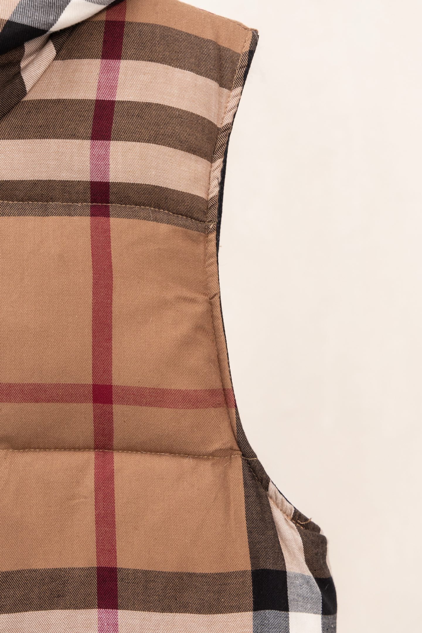 Burberry long plaid puffer jacket with brown quilted panels and vertical check stripes