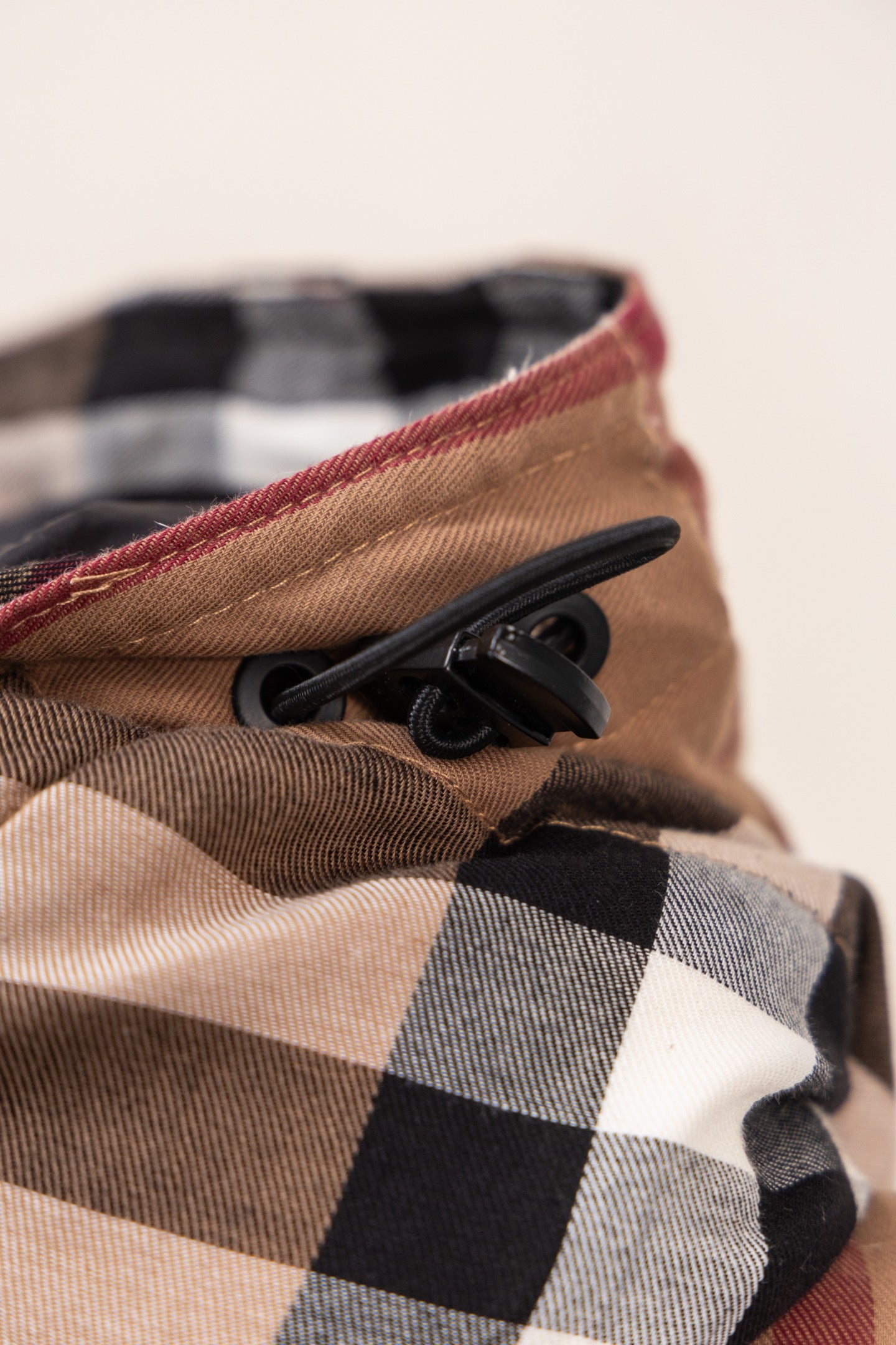 Burberry plaid hood edge with black drawcord and beige lining