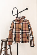 Hooded plaid puffer vest with front zipper and brown, black, white, and red checks