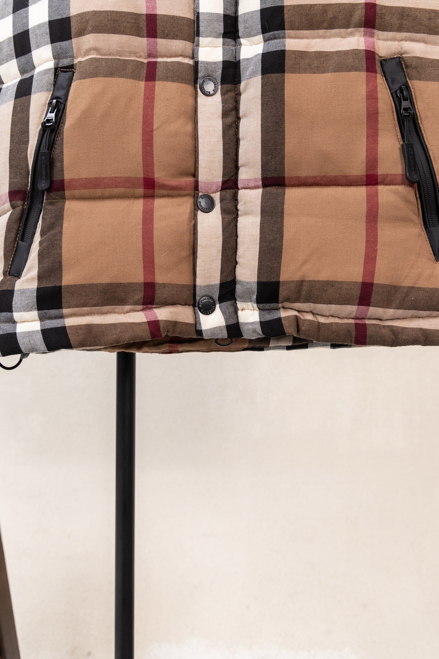 Burberry plaid puffer jacket front with snap buttons and black zippers