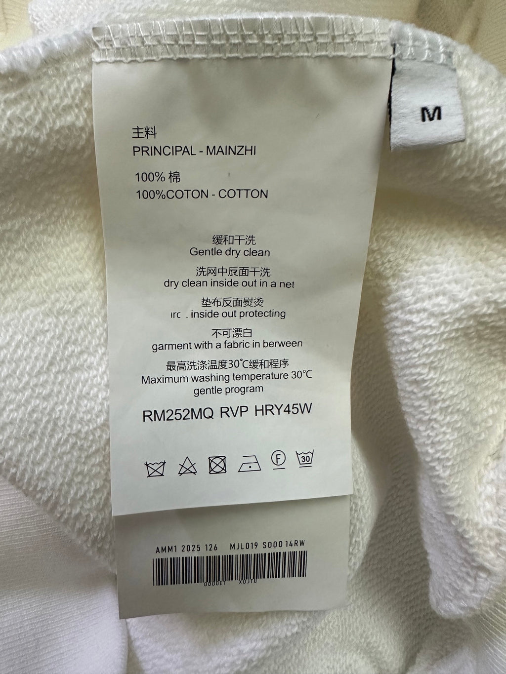 White sweatshirt size M care label with 100% cotton and drying instructions