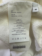 White sweatshirt size M care label with 100% cotton and drying instructions