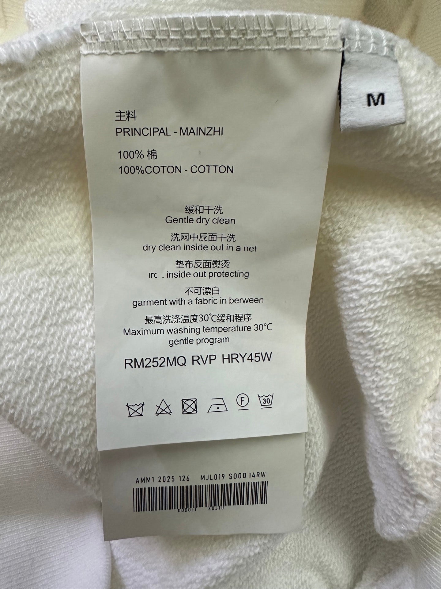 White sweatshirt size M care label with 100% cotton and drying instructions
