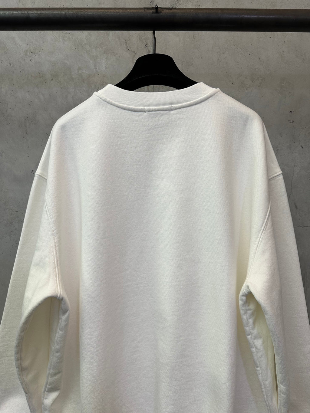 White crewneck sweatshirt back view with ribbed crew neck