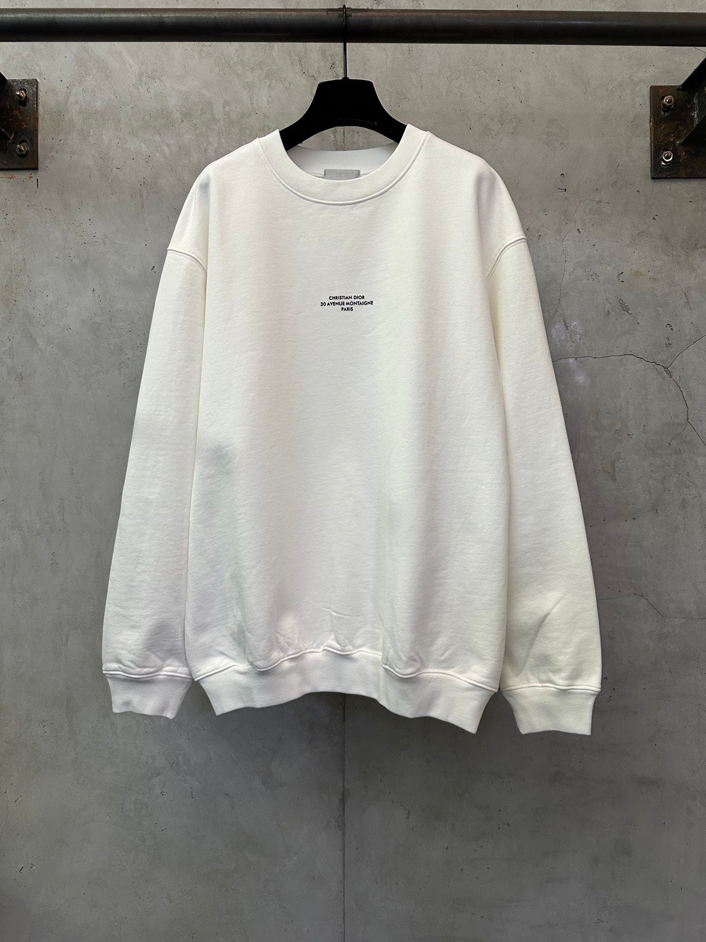 White crewneck sweatshirt with small chest logo on the front