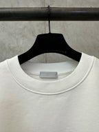White crewneck sweatshirt collar detail on a hanger