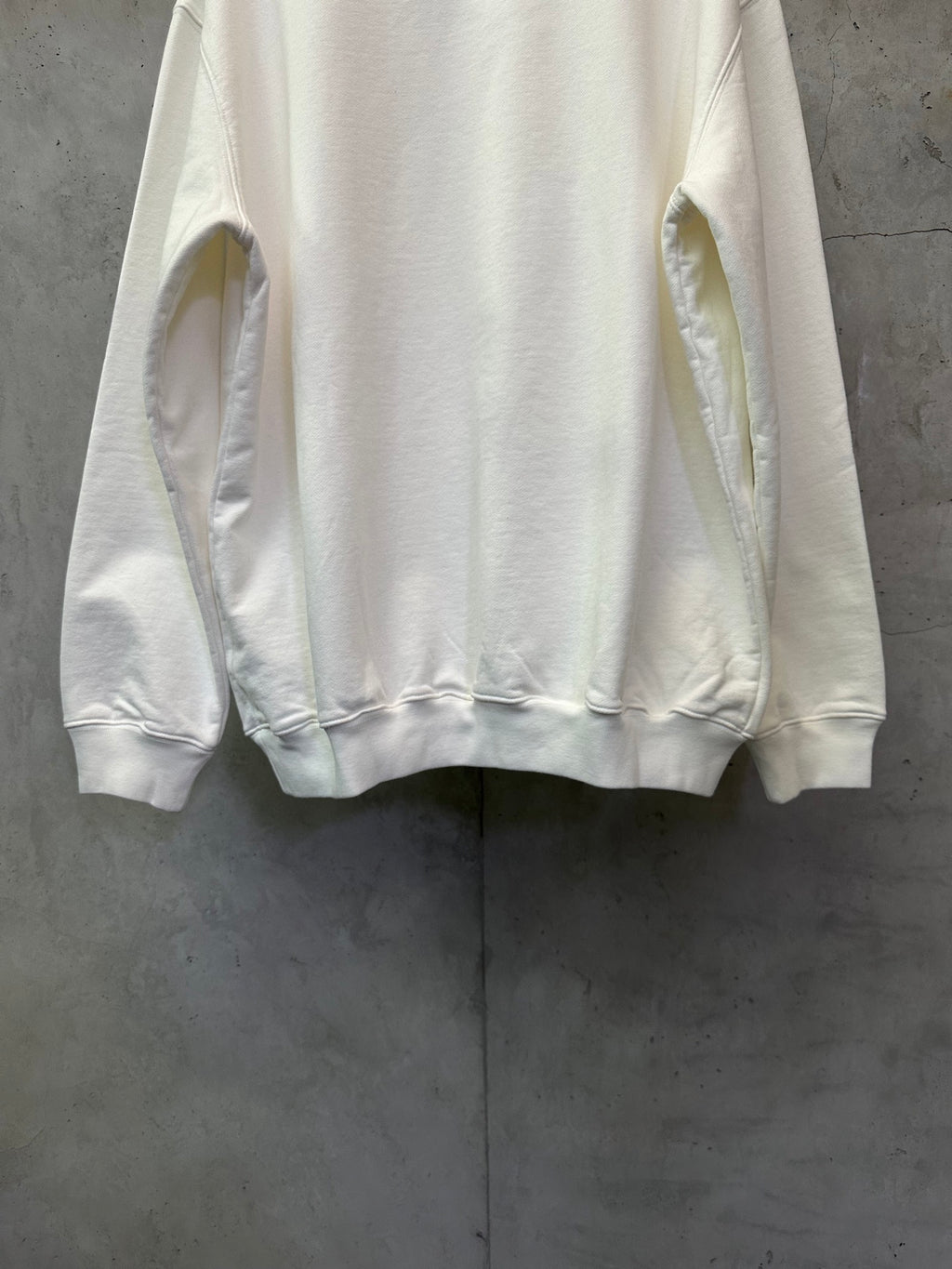 White crewneck sweatshirt back view with cuffs and hem details