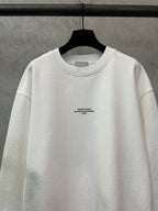 White crewneck sweatshirt with small logo text at the chest