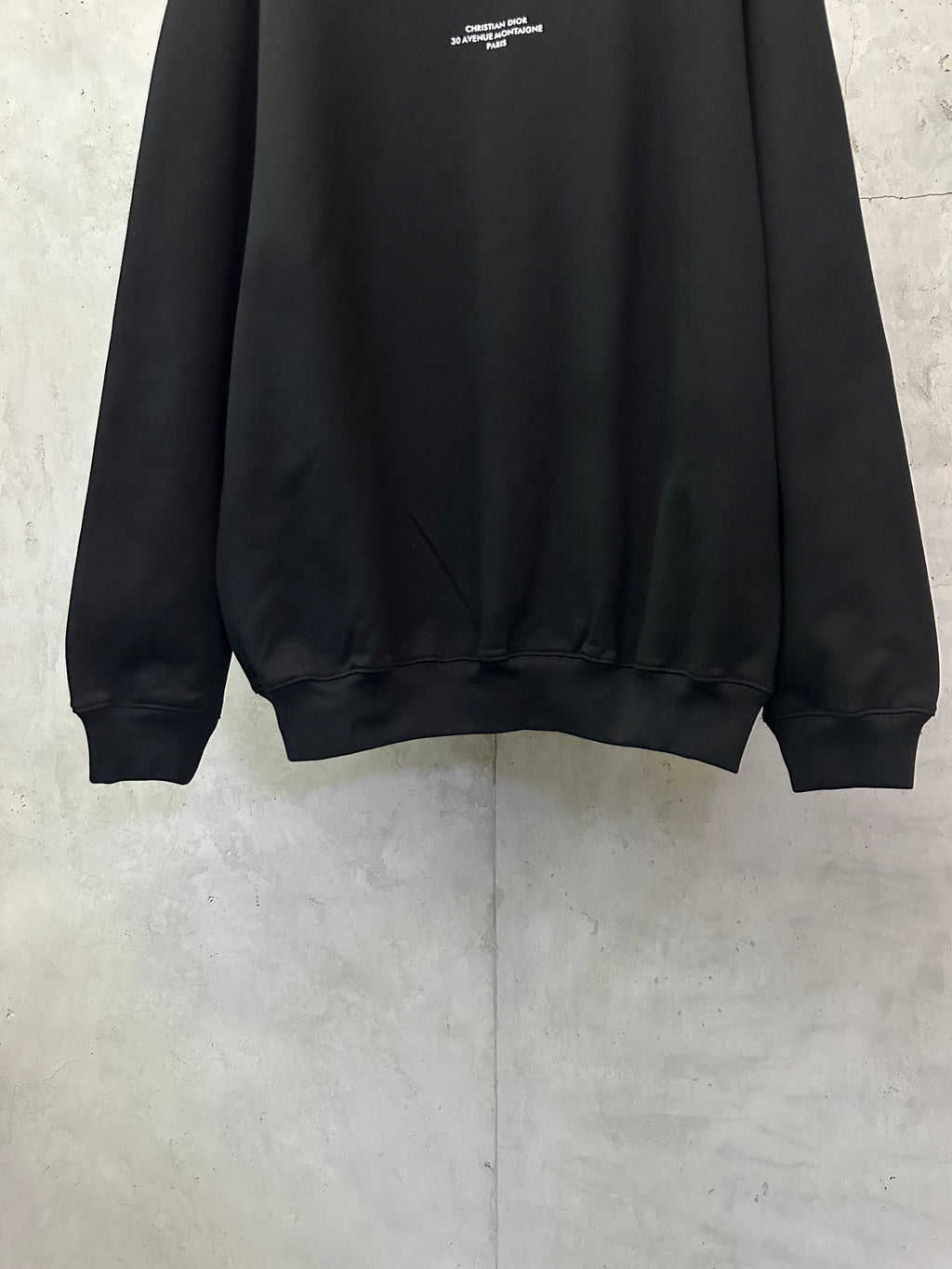 Black crewneck sweatshirt hem and ribbed cuffs