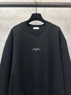Black crewneck sweatshirt with centered chest text logo
