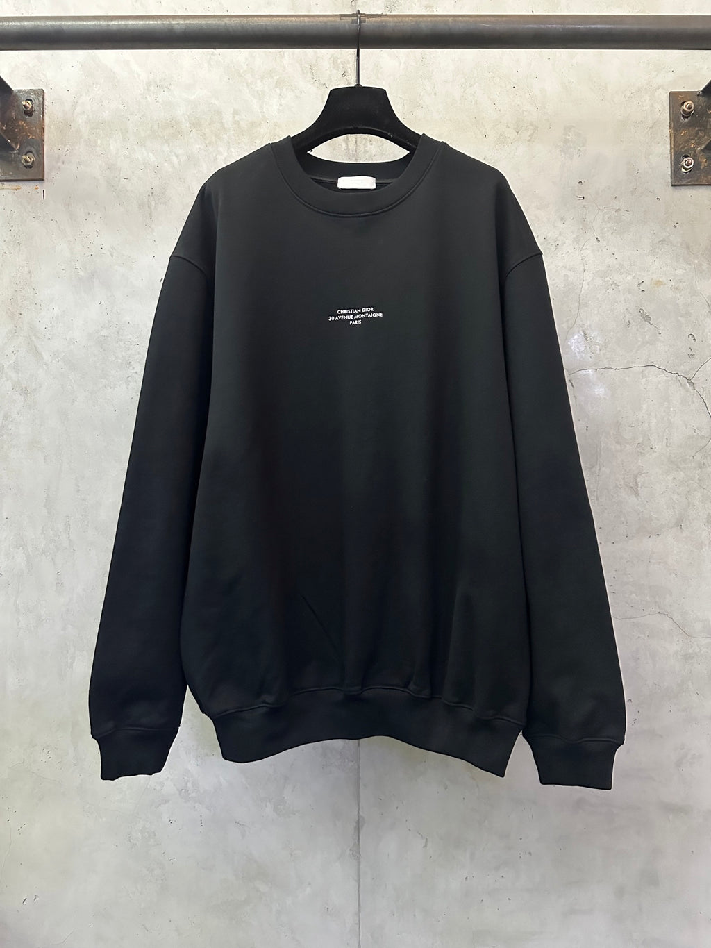 Black crewneck sweatshirt with small chest logo print