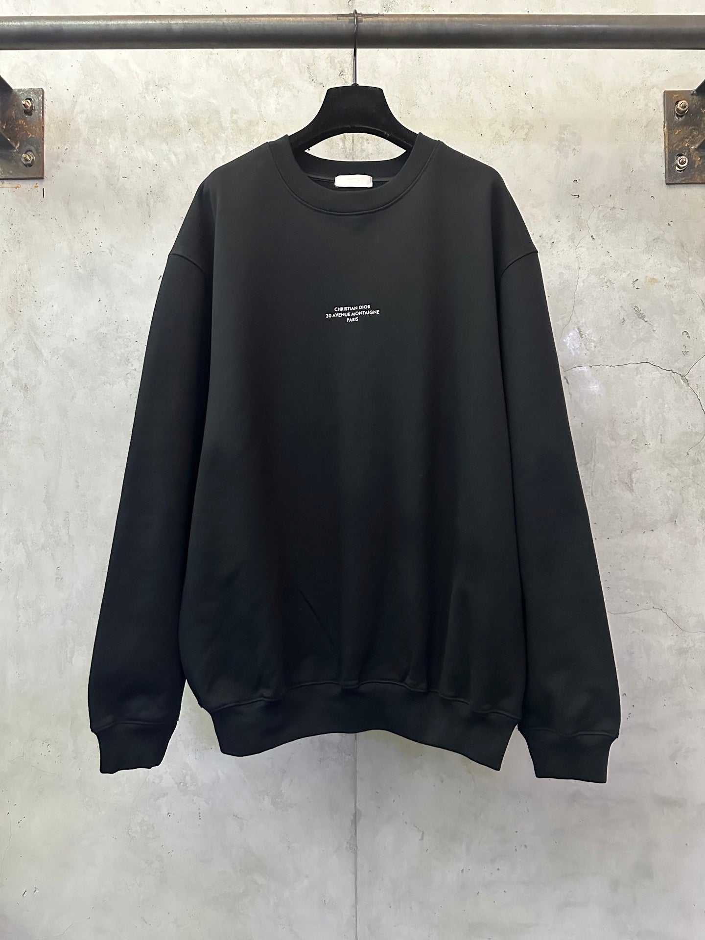 Black crewneck sweatshirt with small chest logo print