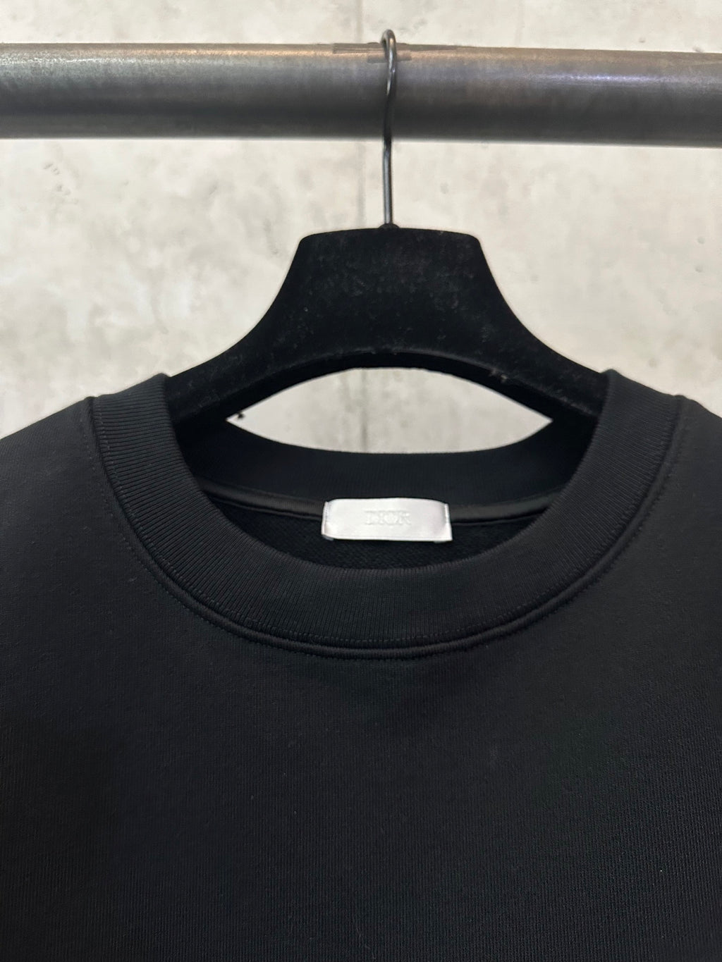 Black crewneck sweatshirt neckline with inner size label