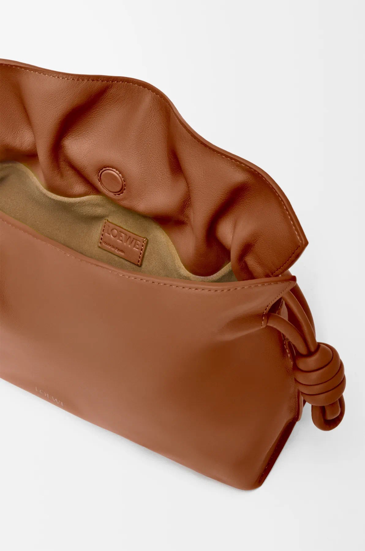 Loewe tan drawstring bag interior view with fabric lining and cord pull hardware