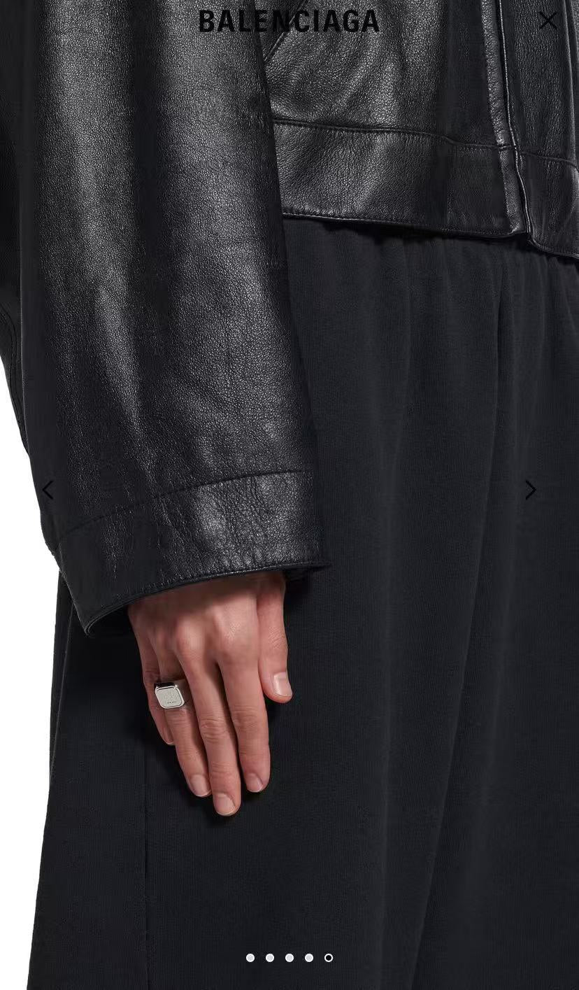 Balenciaga logo ring with white enamel on finger
