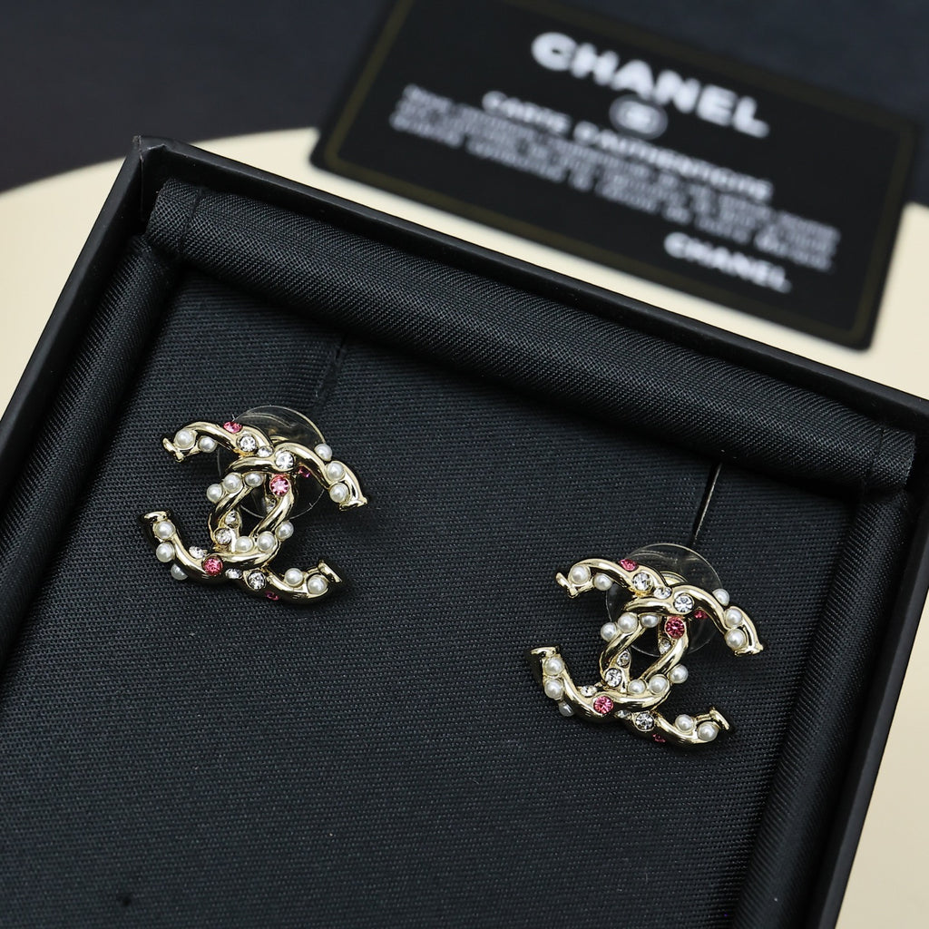Gold-tone logo stud earrings with pink stones and faux pearls, in open case