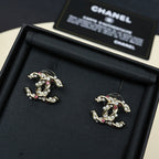 Gold-tone logo stud earrings with pink stones and faux pearls, in open case