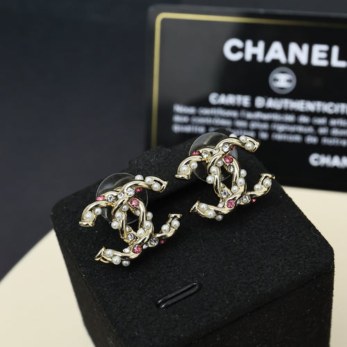 Gold-tone logo stud earrings with pink stones and faux pearls, pair view
